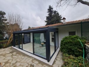 Pergola With Retractable Aluminum Shatters and Sliding Glass Doors